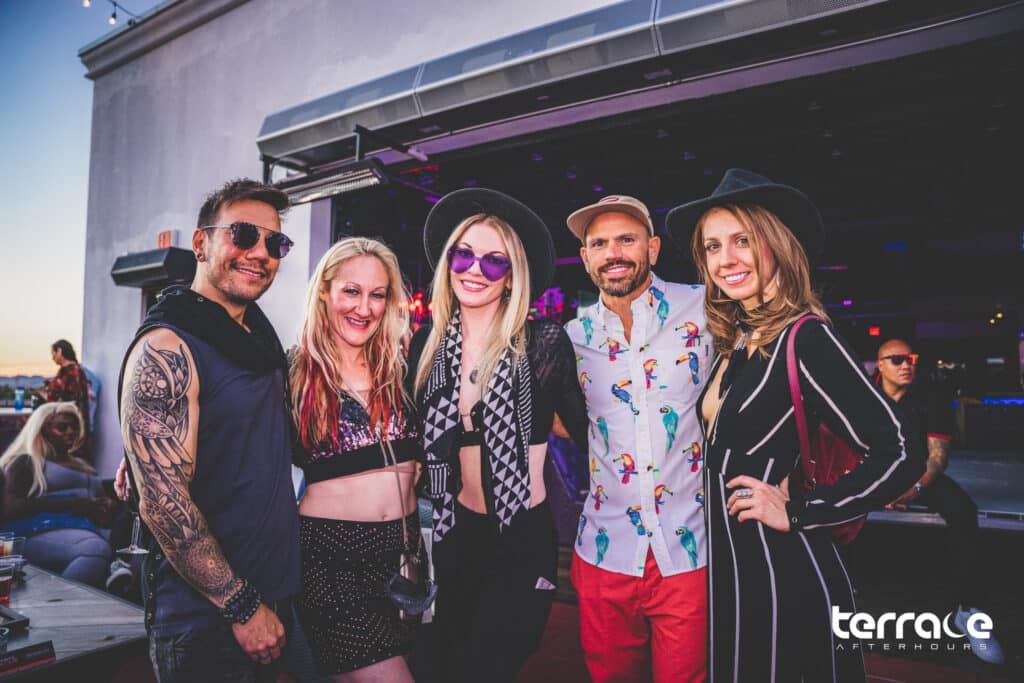 Group of friends smiling for photo at sunrise in Las Vegas Afterhours club