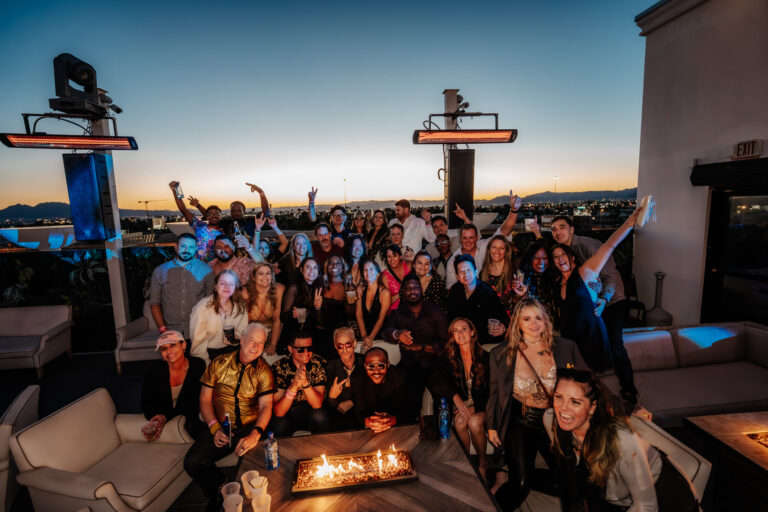 Group of friends posing for photo together at a rooftop party in Las Vegas