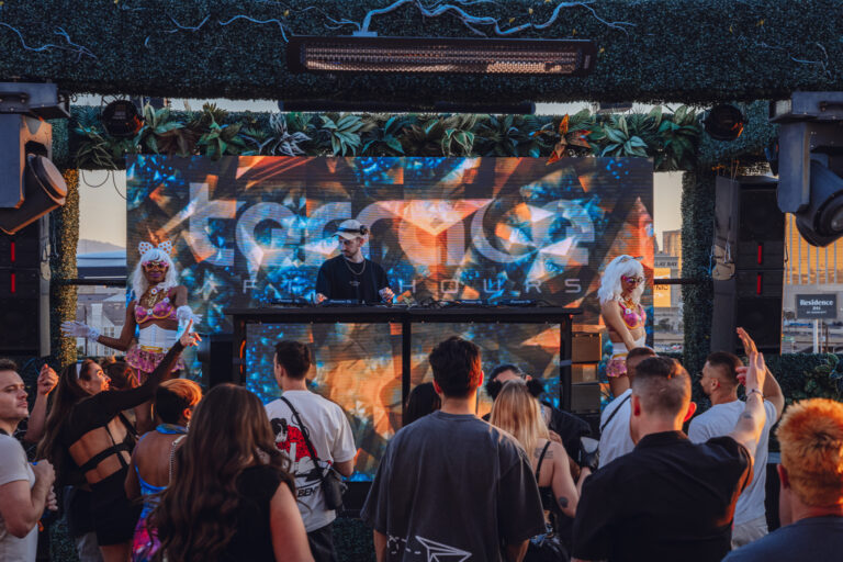 DJ performing underground house music at sunrise on rooftop of Las Vegas Afterhours club