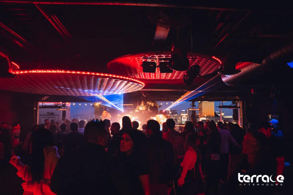 crowd dancing at Terrace Afterhours with DJ, lighting, and stage design in Las Vegas