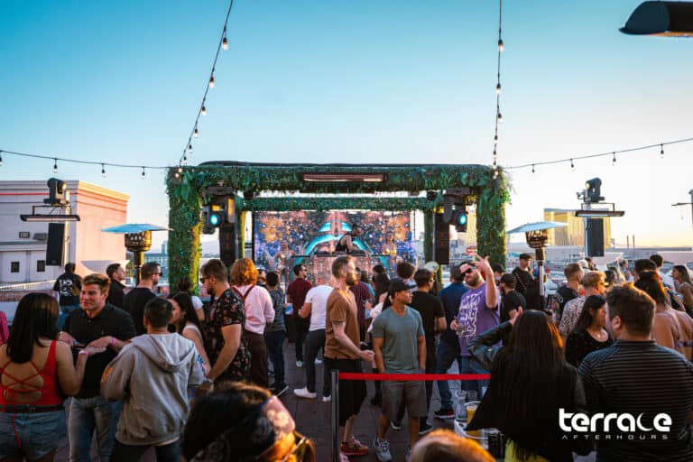 People enjoying house music during sunrise at open-air rooftop club in Las Vegas