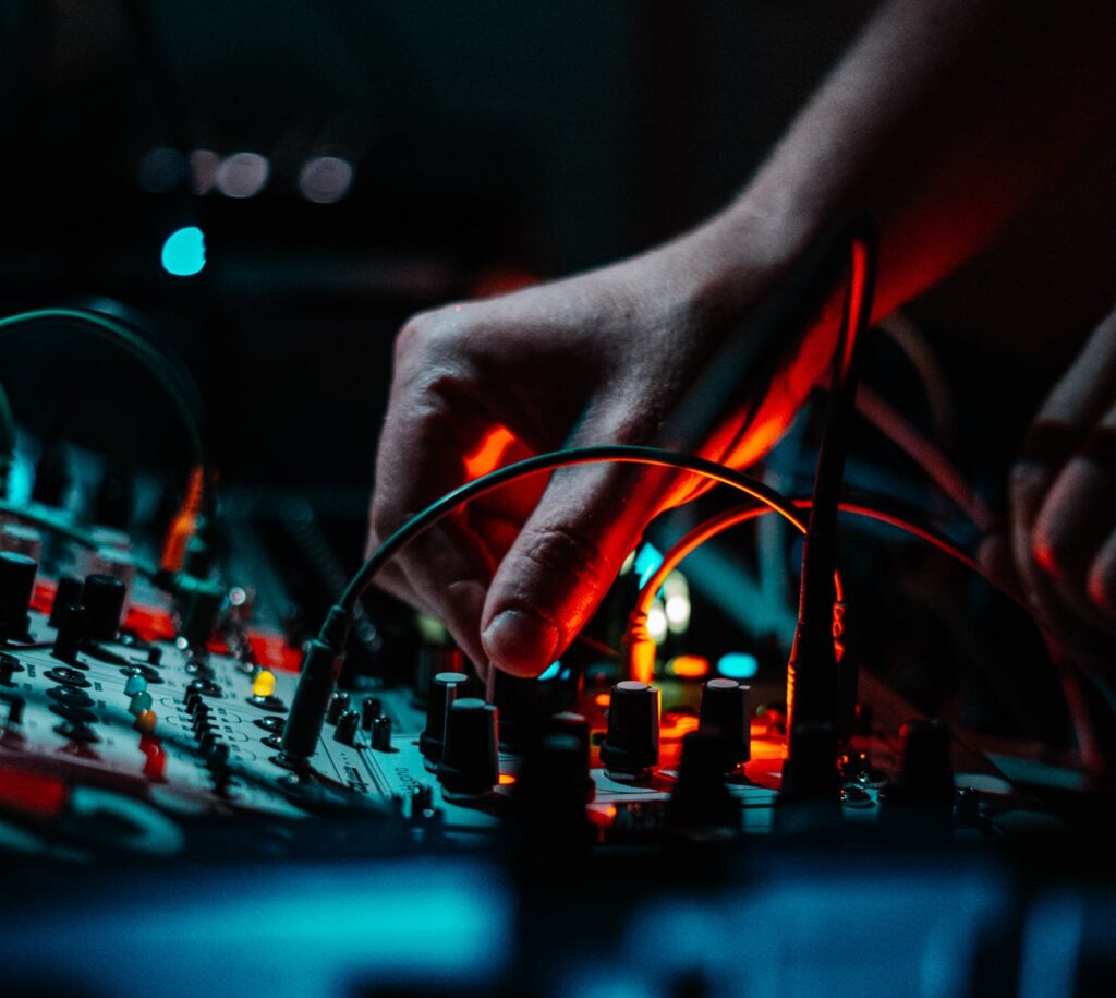 Up close image of a lighting technician's twisting knob at edm club