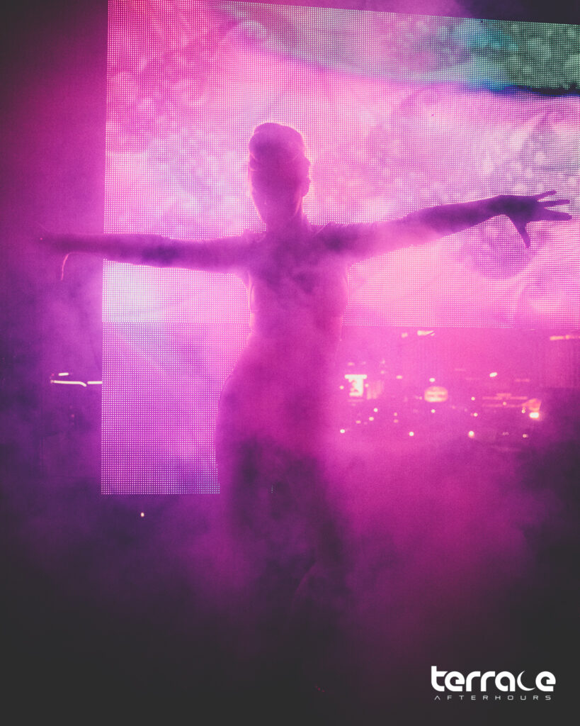silhouette of gogo dancer behind pink haze at Terrace Afterhours nighclub