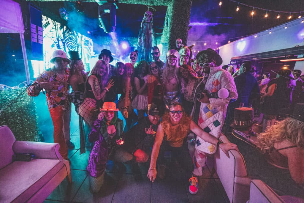 Group of friends dressed up in different costumes posing for photo at las vegas halloween event
